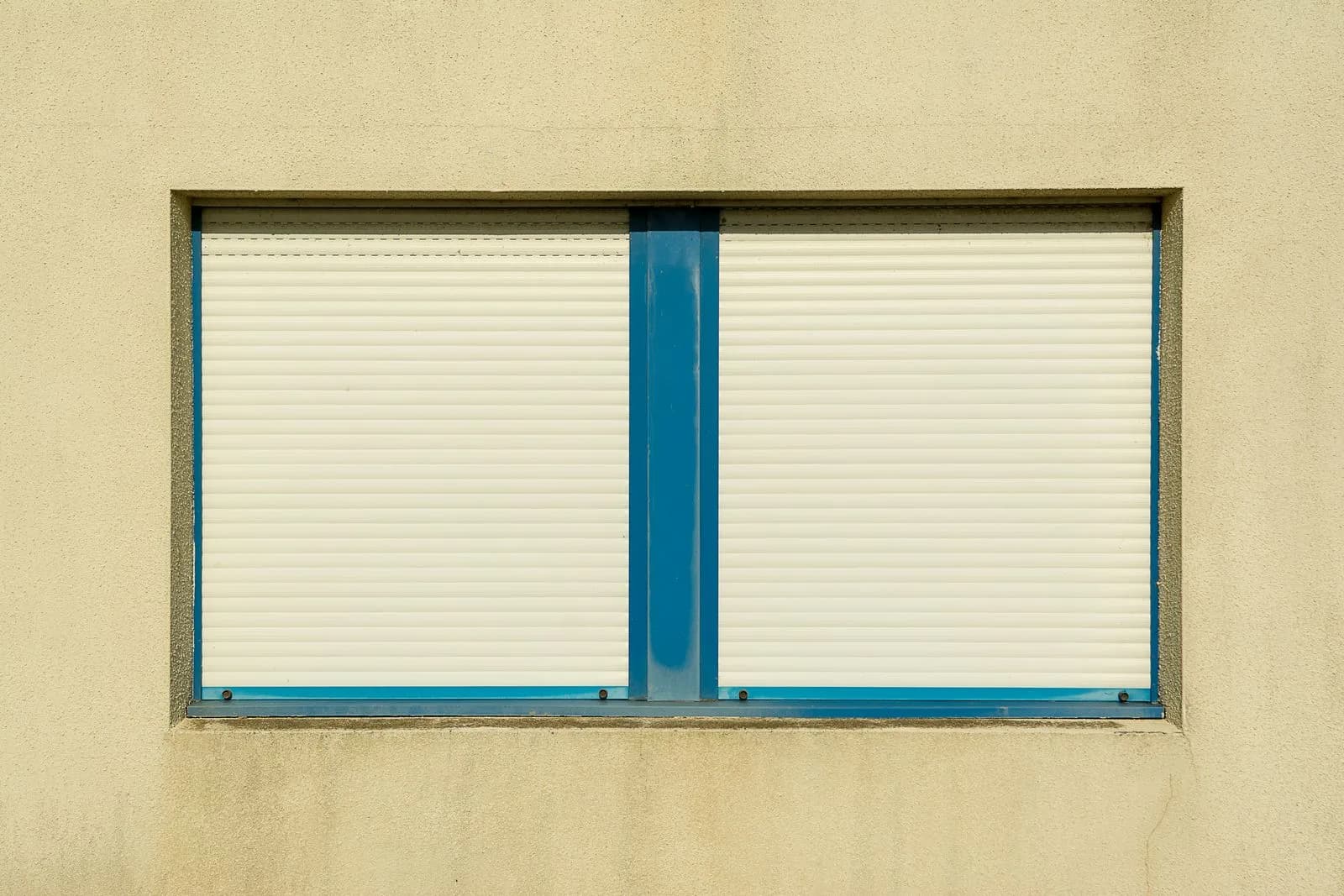 Closed shutters protecting two facade windows