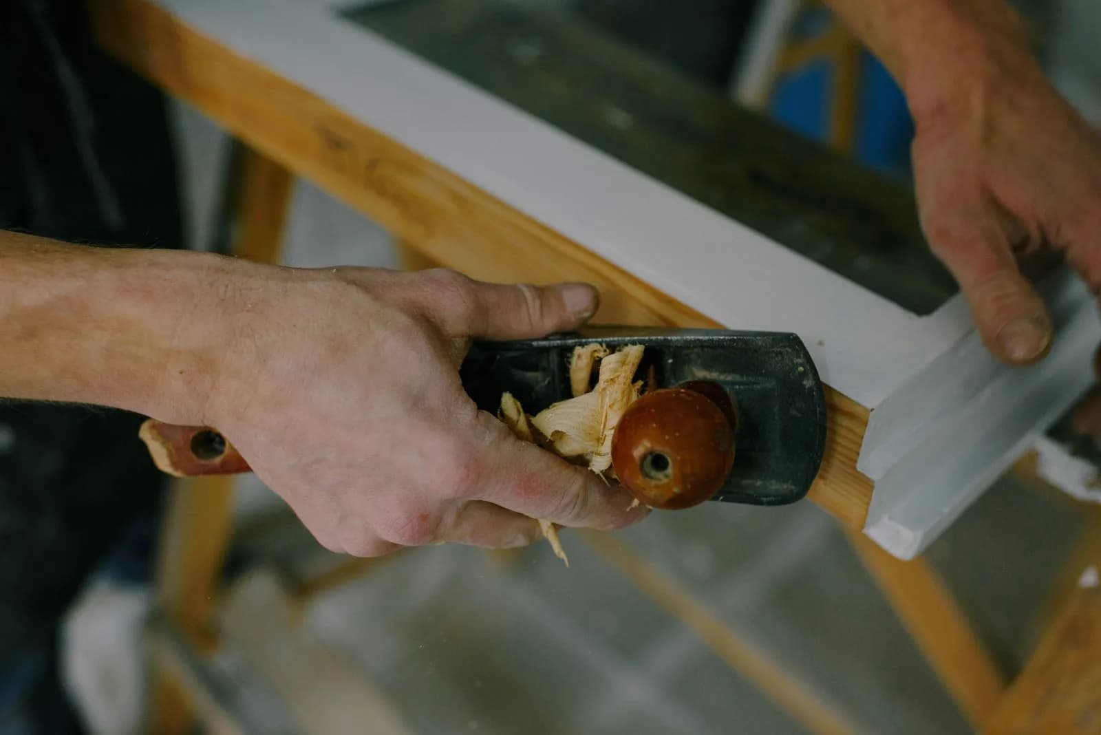 Carpenter working on a wooden window frame